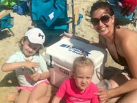 Dr. Katie Johnson enjoys a day on the beach with her daughters, (left to right) Emerson and Finley, and their new “I Believe in Beebe” Yeti cooler.